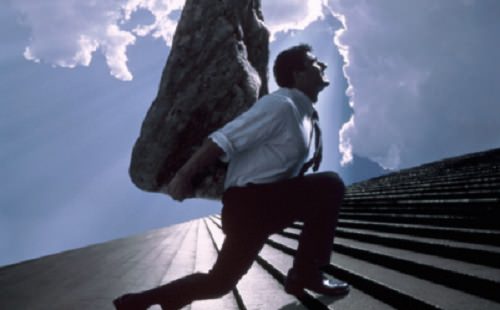Man carrying boulder up steps